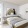 A bedroom with a large bed and a painting on the wall.