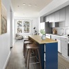 a kitchen with a prep island and barstool seating