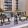 a group of people standing on a balcony above a swimming pool