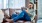 a person sitting on a couch and holding a tablet